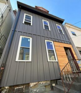 Pittsburgh building exterior with new metal roofing and siding, illustrating commercial roofing project considerations.