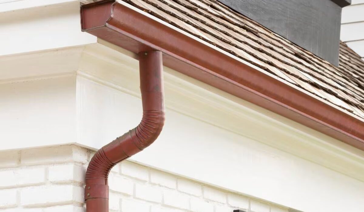 Gutter system on a residential home with a downspout, highlighting the importance of gutter maintenance for Pittsburgh homeowners.