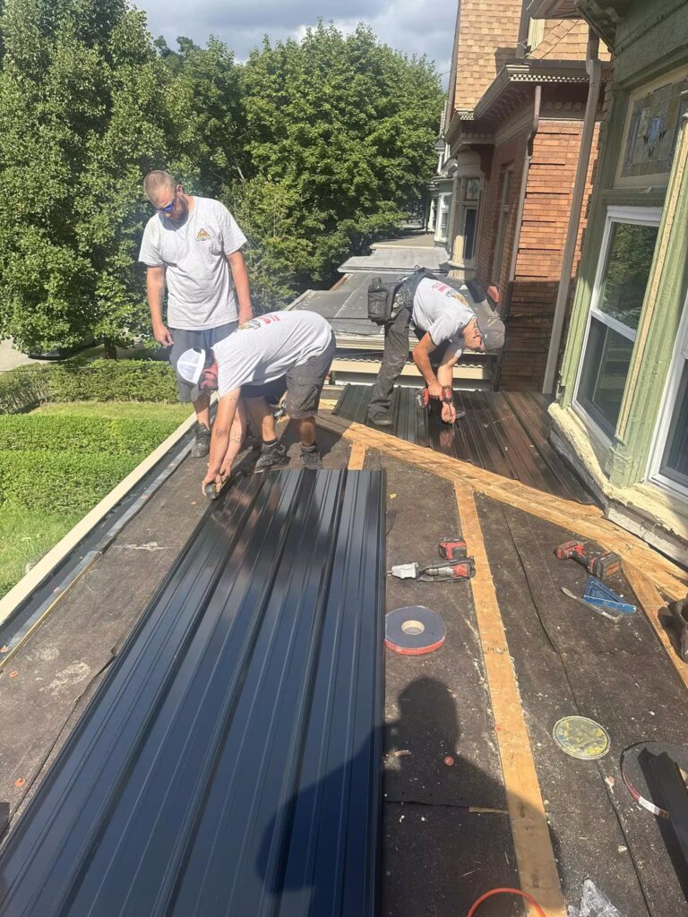 Malick Brothers Exteriors installing metal roofing in Pittsburgh, improving energy efficiency.