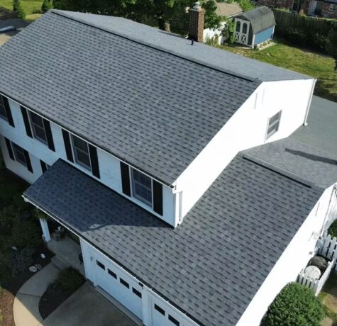 Aerial view of a newly installed asphalt shingle roof on a suburban home, showcasing modern roofing solutions by Malick Brothers Exteriors, designed for Pittsburgh homeowners.