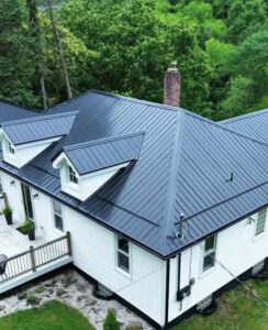 Modern metal roofing on a white residential home surrounded by greenery, showcasing a durable and stylish option for Pittsburgh homeowners.