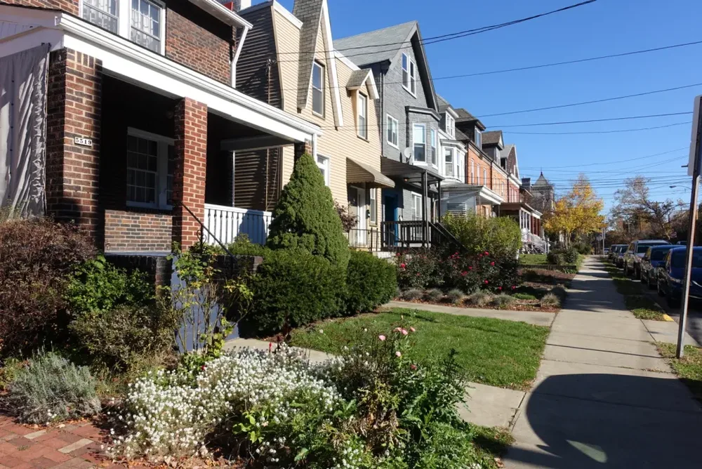 Historic homes in Squirrel Hill and Shadyside, showcasing diverse architectural styles and well-maintained landscaping, emphasizing the need for tailored roofing solutions.