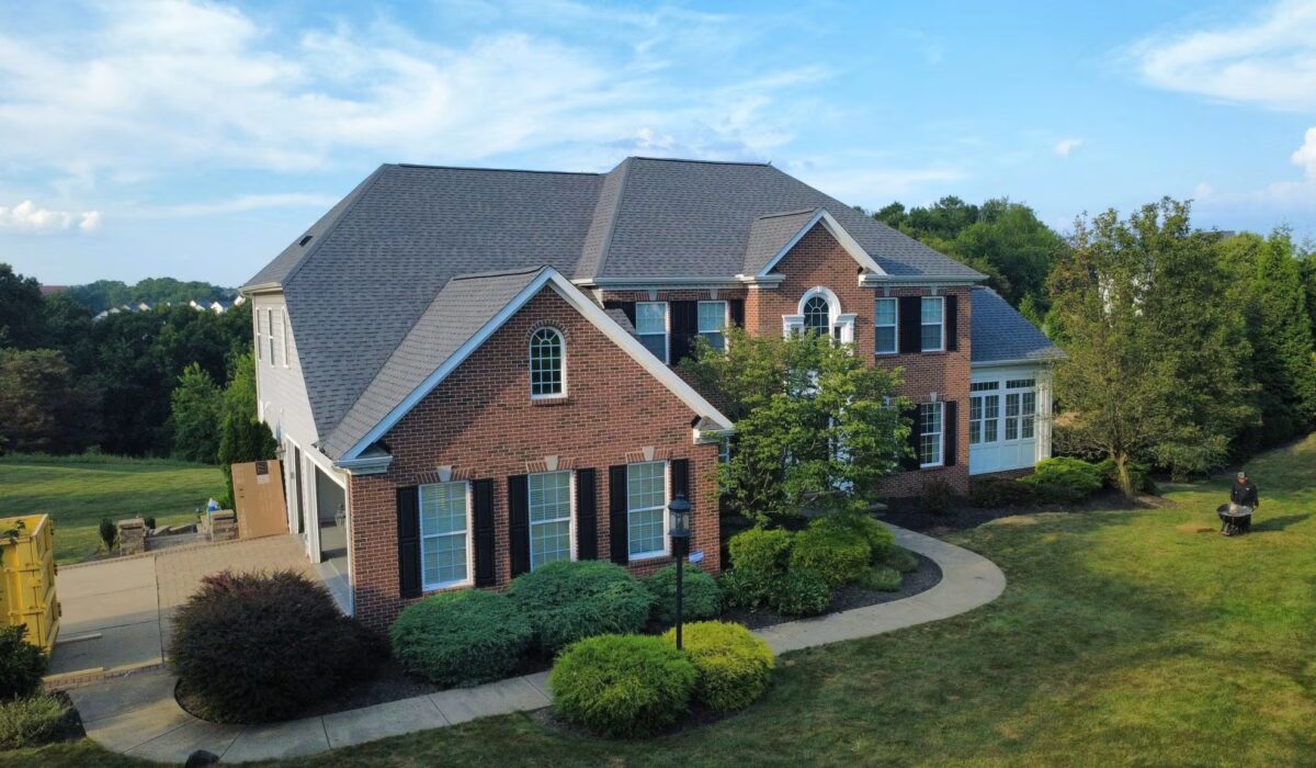 Residential home in Pittsburgh with a well-maintained roof and landscaped yard, showcasing preparation for winter weather.
