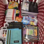 Basket filled with school supplies including markers, notebooks, and pens, highlighting community support for local students in Pittsburgh.