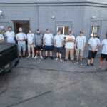 Group of roofing professionals from Malick Brothers Exteriors standing together outside their office, showcasing teamwork and expertise in metal roofing services in Pittsburgh.