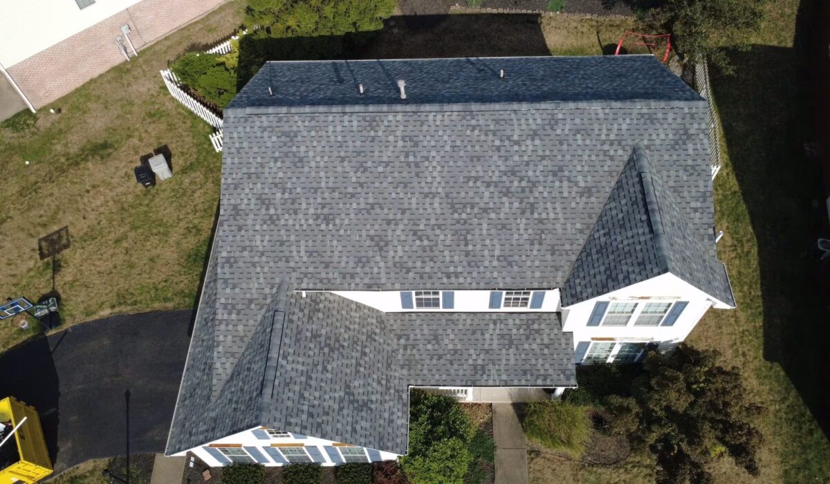Aerial view of a residential roof featuring gray shingles, showcasing roofing quality relevant to Pittsburgh homeowners budgeting for 2025.