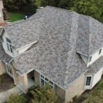 Aerial view of a residential roof with asphalt shingles, highlighting the roof's condition and design relevant to commercial roofing considerations in Pittsburgh.