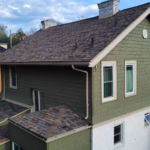 Roof of a commercial building in Pittsburgh, featuring proper drainage systems, sloped design, and insulated pipes, emphasizing the importance of effective water management in local weather conditions.
