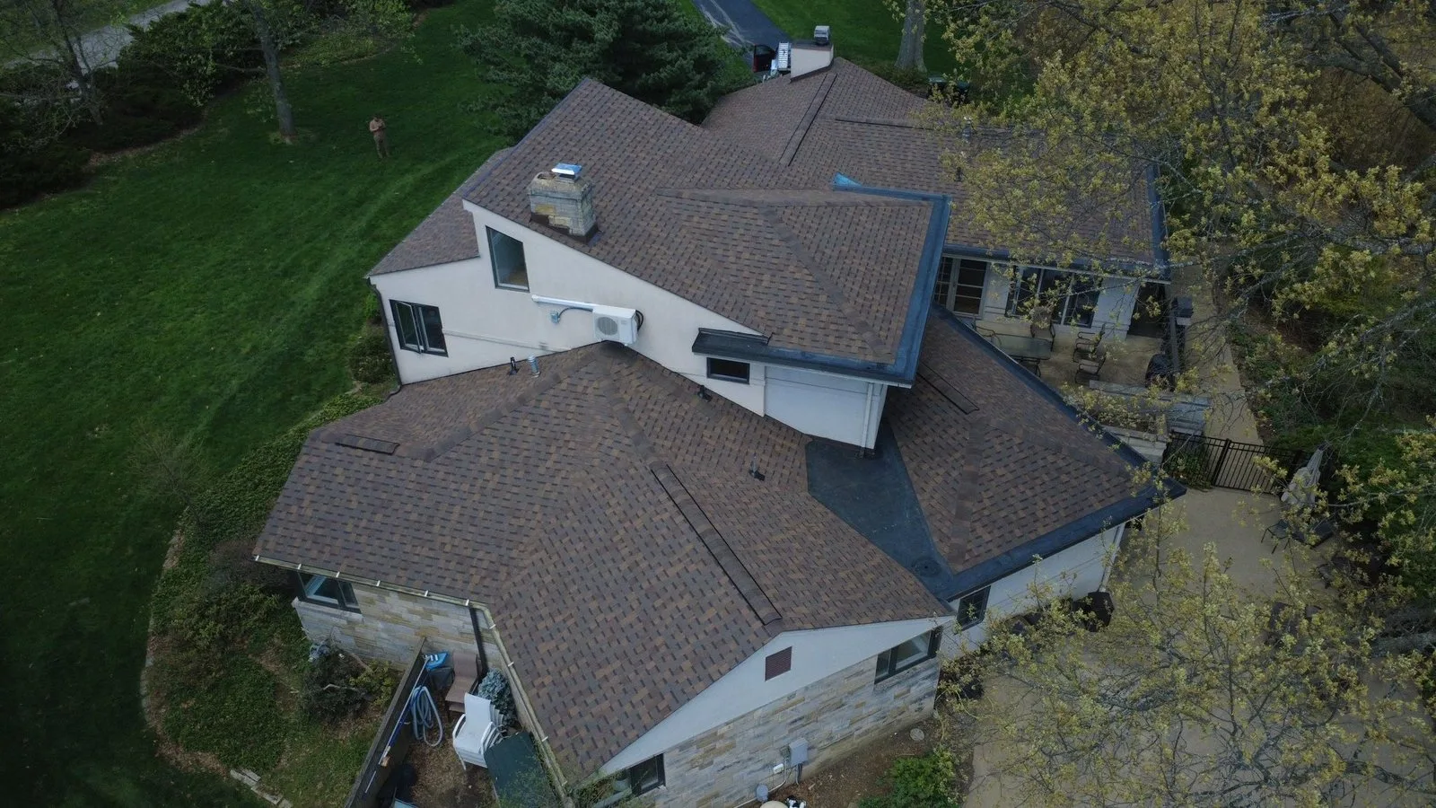 Close view of Atlas Copper Canyon shingles with new flashing and flat roof sections on an Allison Park home by Malick Brothers Exteriors