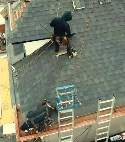 Malick Brothers crew removing old shingles during a roof tear off