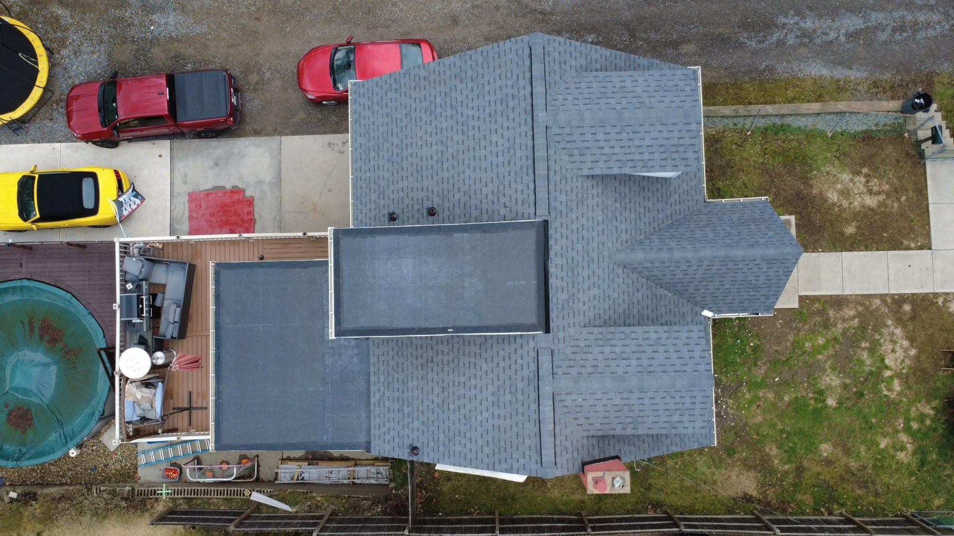 Overhead view of a home with shingles on the steep sections and flat roof sections by Malick Brothers Exteriors in the Pittsburgh area