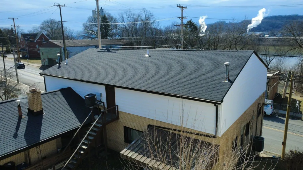 New siding, soffit, fascia and gutters on a multi unit building in Baden by Malick Brothers Exteriors