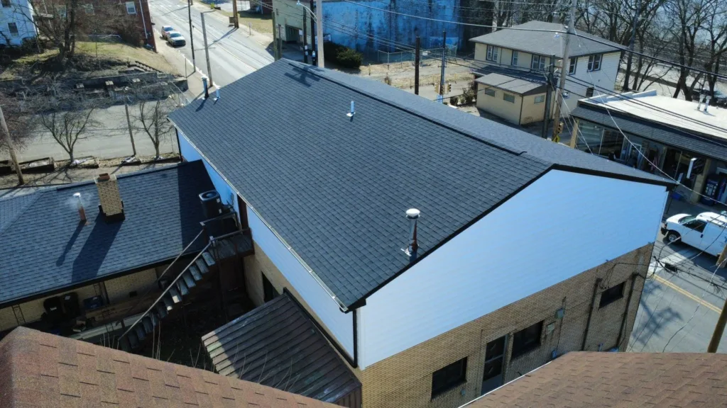 New siding, soffit, fascia and gutters on a multi unit building in Baden by Malick Brothers Exteriors