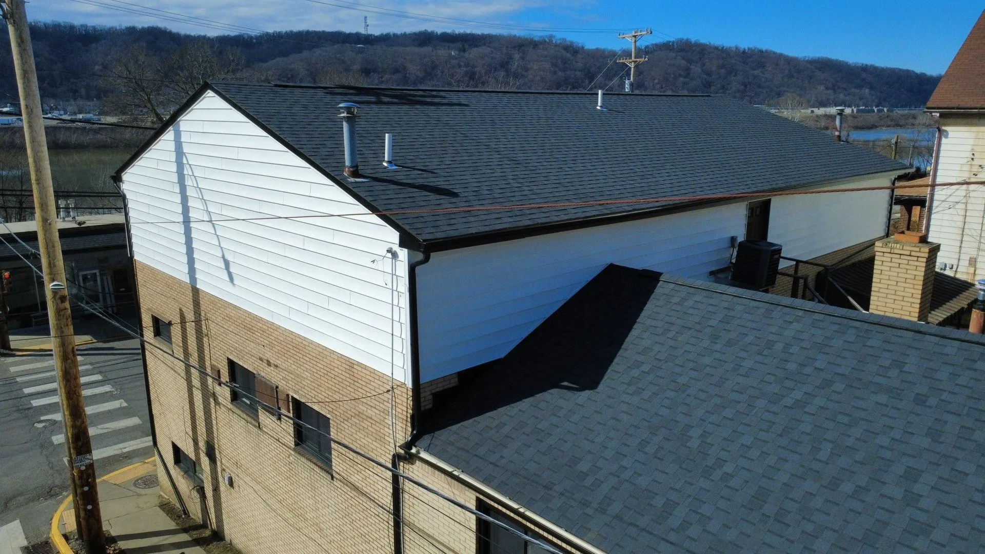 New siding, soffit, fascia and gutters on a multi unit building in Baden by Malick Brothers Exteriors