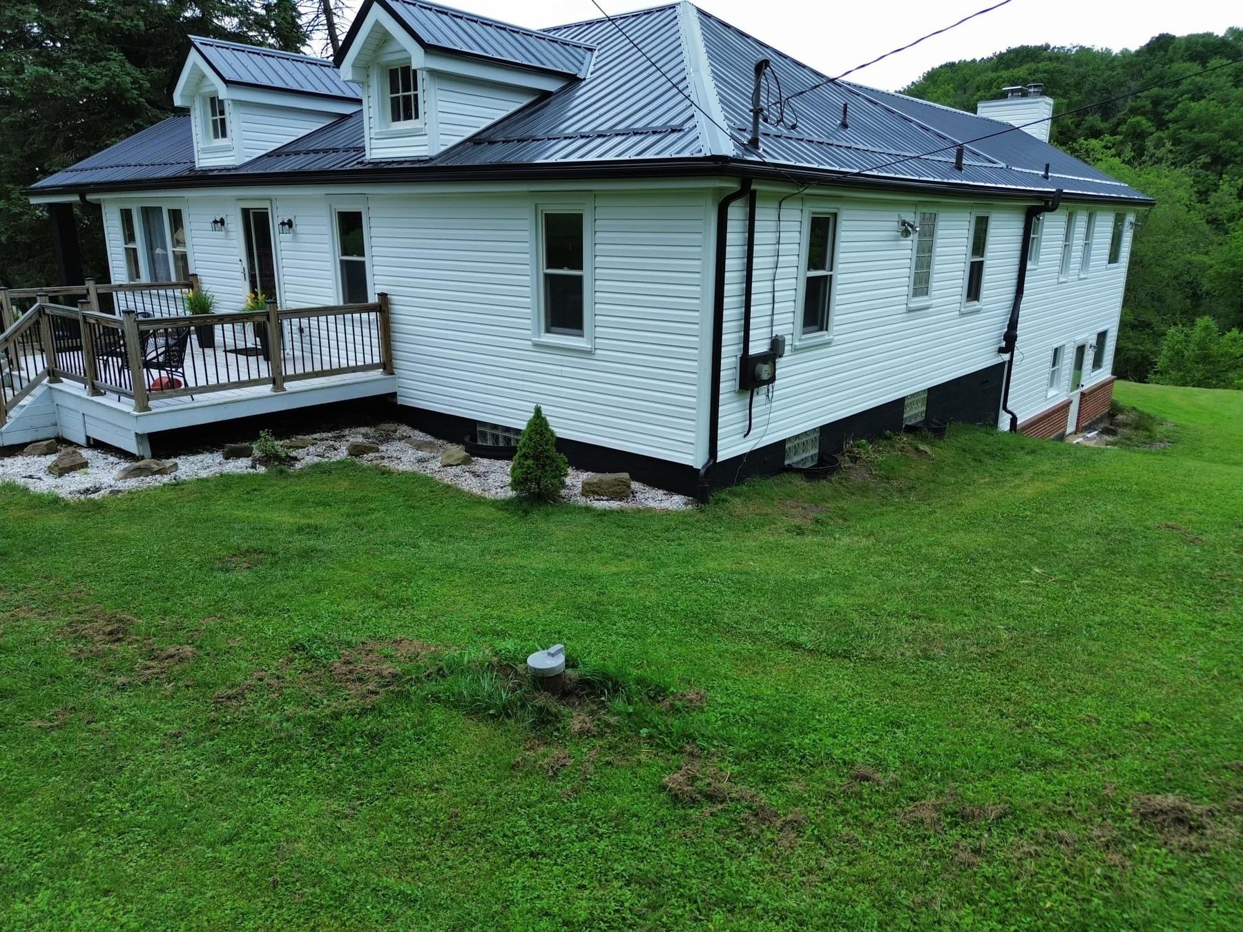 Dark metal roof installed by Malick Brothers Exteriors on a Wexford home with dormers