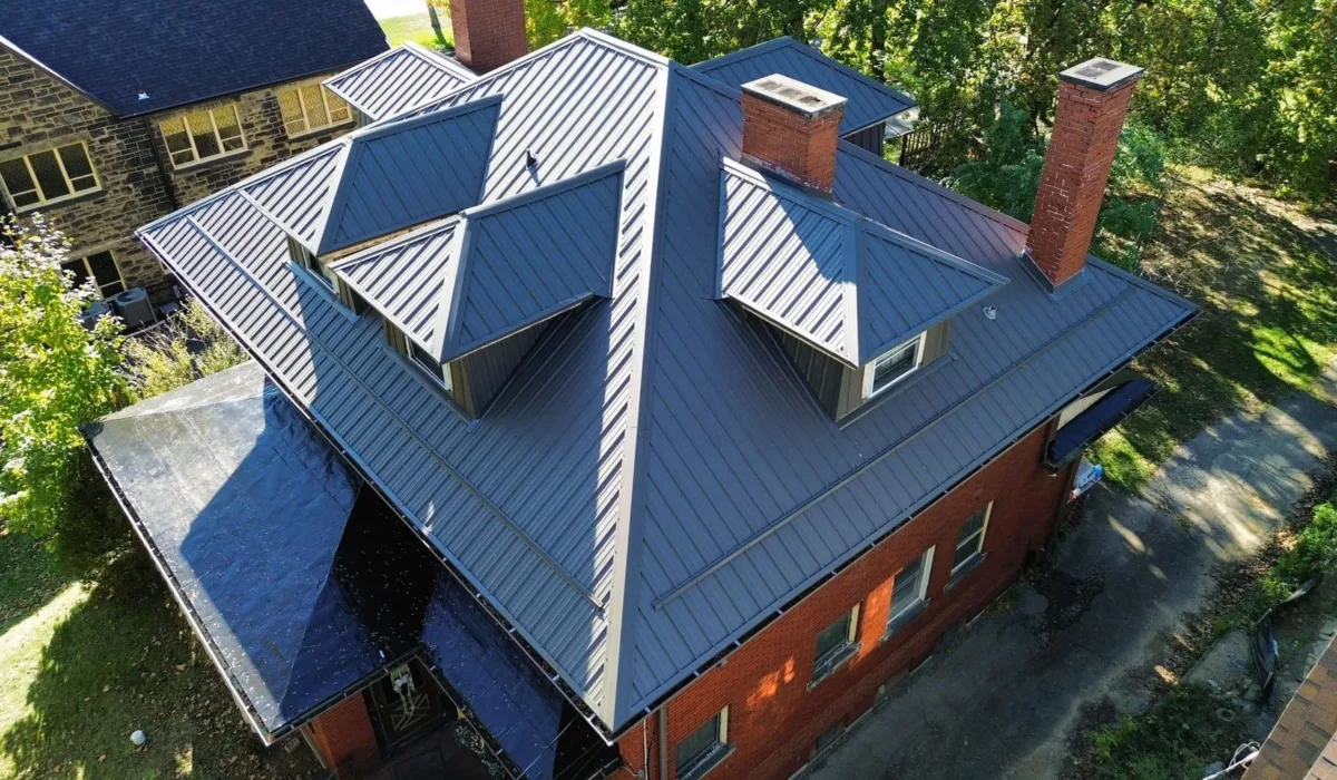 Standing seam metal roof with dormers and chimneys by Malick Brothers Exteriors