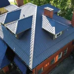 Standing seam metal roof with dormers and chimneys by Malick Brothers Exteriors
