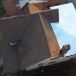 Silver standing seam metal roof section installed by Malick Brothers Exteriors in Bellevue