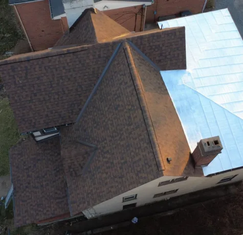Silver standing seam metal roof section installed by Malick Brothers Exteriors in Bellevue