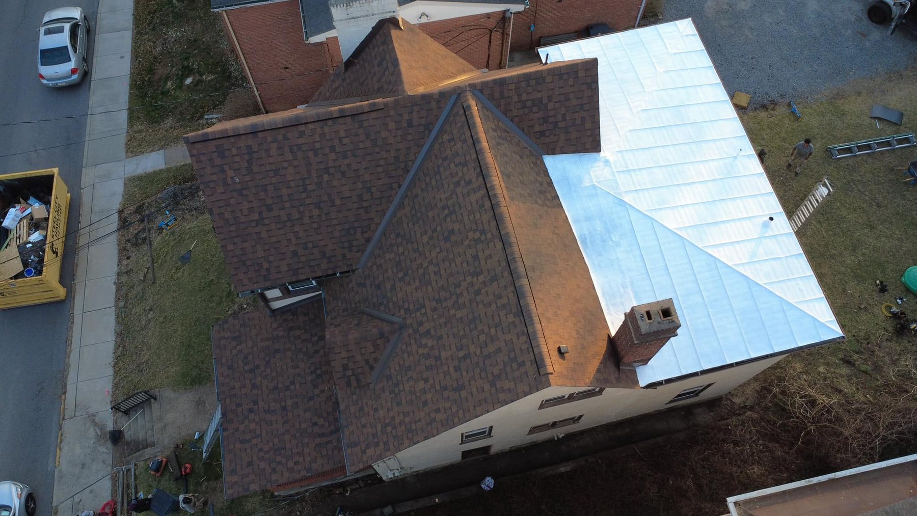 Silver standing seam metal roof section installed by Malick Brothers Exteriors in Bellevue