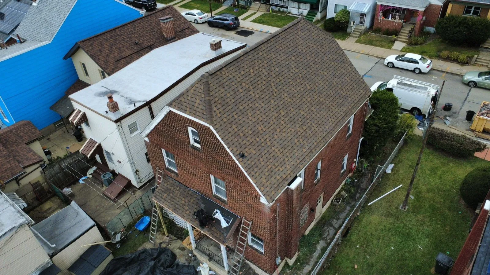 Finished shingle roof on a brick home in Morningside with the back porch roof being rebuilt by Malick Brothers