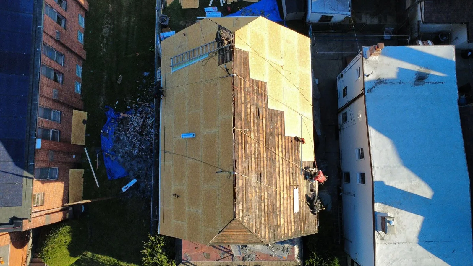 Malick Brothers crew installing new roof decking over old plank boards on a home in Morningside, Pittsburgh