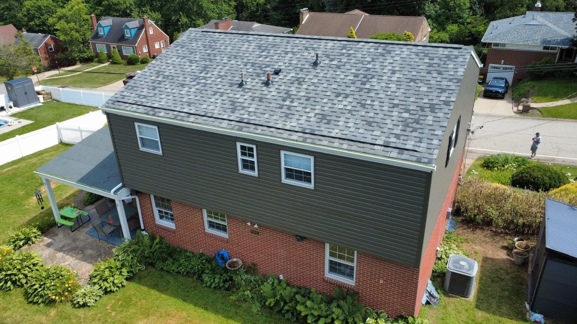 Dark siding installed by Malick Brothers Exteriors on the upper story of a brick Pittsburgh area home